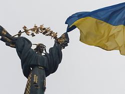 a ukrainian national flag waves in front of the independence monument amid russia s attack on ukraine in kyiv ukraine november 26 2025
