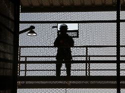 a police officer stands guard during a media tour at the terrorism confinement center cecot prison in tecoluca el salvador april 4 2025