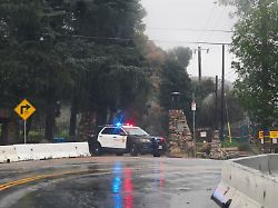 a police vehicle stands on a rain soaked road as heavy rains from an atmospheric river hit altadena california u s december 24 2025