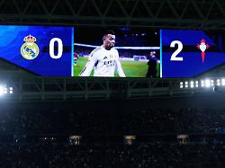 a screen shows the score and real madrid s kylian mbappe leaving the field at the end of the spanish la liga soccer match between real madrid and celta vigo in madrid spain sunday dec 7 2025 1