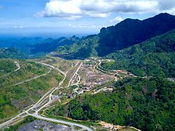 aerial view over panguna mine looking at the entry to the mine and the coast