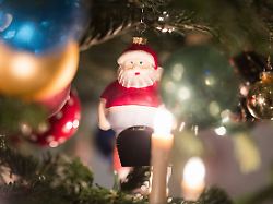 blick auf einen mit figuren und kugeln geschmueckten tannenbaum