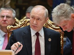 der russische praesident wladimir putin l spricht mit kreml sprecher dmitri peskow waehrend des gipfels der gemeinschaft unabhaengiger staaten im palast der nation