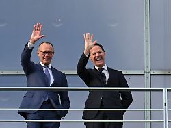 german chancellor friedrich merz and nato secretary general mark rutte wave from the terrace of the chancellery at a group of young people on the courtyard in berlin germany december 11 2025