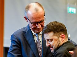german chancellor friedrich merz hugs ukrainian president volodymyr zelenskiy as they attend the 8th german ukrainian business forum at the house of the german economy in berlin germany december 15 2025