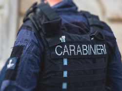 italian carabinieri national gendarmerie of italy squad of italy patrol formation back view with carabiners logo emblem on uniform maintain public order in the streets of florence italy italia