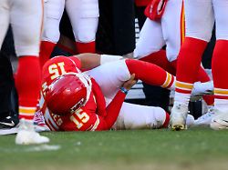 kansas city chiefs quarterback patrick mahomes grabs his knee after being injured during the second half of an nfl football game against the los angeles chargers sunday dec 14 2025 in kansas city mo