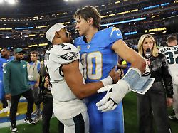 los angeles chargers quarterback justin herbert 10 hugs philadelphia eagles quarterback jalen hurts 1 after an nfl football game monday dec 8 2025 in inglewood calif
