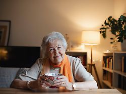 lovely elderly woman sitting at the kitchen table and drinking a tea lovely elderly woman sitting at the kitchen table and drinking a tea portrait of senior woman at home