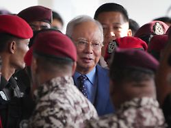 malaysian former prime minister najib razak center is escorted by prison officers on his arrival at the kuala lumpur high court complex in kuala lumpur malaysia on oct 30 2024