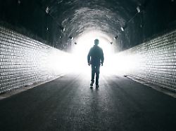 man walking to light