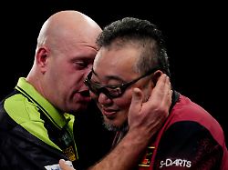 michael van gerwen left speaks with mitsuhiko tatsunami after winning their match on day eight of the paddy power world darts championship at the alexandra palace in london thursday dec 18 2025