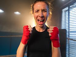 outcry independent girl power angry strong crazy woman fighter screaming looking aggressive on boxing ring