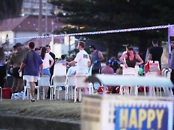 people and emergency workers gather at location where a holiday event was taking place and then a reported shooting at bondi beach in sydney sunday dec 14 2025