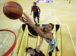 san antonio spurs forward victor wembanyama right dunks the ball past new york knicks guard tyler kolek in the second half of an nba cup championship basketball game tuesday dec 16 2025 in las vegas