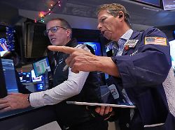 specialist glenn carell left and trader robert charmak work on the floor of the new york stock exchange thursday dec 11 2025
