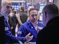 specialists philip finale left and gennaro saporito center confer with a colleague on the floor of the new york stock exchange monday nov 24 2025