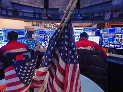 a pair of traders work on the floor of the new york stock exchange monday jan 12 2026