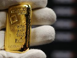 a worker holds a gold bar at barcelona gold store in barcelona spain january 26 2026