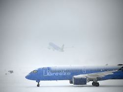 albany ny january 26 a breeze airways jet taxis to the deicing station at albany international airport as another breeze jet departs on monday jan 26 2026 in colonie n y