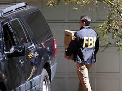 an fbi agent carries boxes outside the home of the former white house national security adviser john bolton as it is searched by fbi in bethesda maryland u s august 22 2025