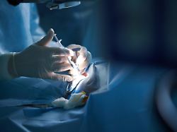 crop unrecognizable doctor in uniform with syringe injecting medicine into body of patient during surgery in hospital model released sergeymironov surgery 48