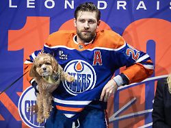 edmonton oilers leon draisaitl stands with his dog before being honored for his 1000th point before an nhl hockey game against the los angeles kings in edmonton alberta saturday jan 10 2026