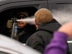 ein beamter der einwanderungsbehoerde setzt pfefferspray ein als beamte in minneapolis eine verhaftung vornehmen