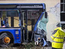 ein linienbus wird nach seinem aufprall auf eine betonmauer geborgen bei dem unfall kam eine person ums leben mehrere wurden verletzt