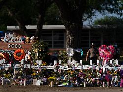 file flowers and candles are placed around crosses to honor the victims killed in a school shooting may 28 2022 outside robb elementary school in uvalde texas ap photo jae c