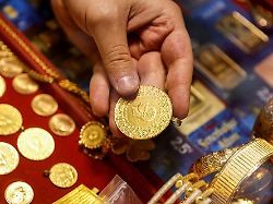 file photo a goldsmith holds a gold coin at a jewellery shop at the grand bazaar also known as the covered bazaar in istanbul turkey january 26 2026