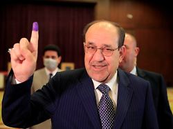 file photo former iraqi prime minister nouri al maliki shows his inked finger at a polling station in baghdad as iraqis go to the poll to vote in the parliamentary election in iraq october 10 2021