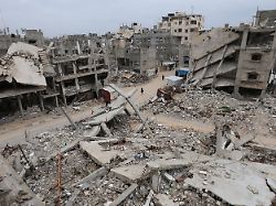 file photo palestinians walk surrounded by the rubble of houses destroyed in israeli strikes during the war in khan younis southern gaza strip january 22 2026
