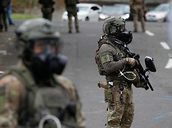immigration and customs enforcement agents stand outside an ice facility during a protest on saturday oct 4 2025 in portland ore