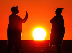 january 1 2026 isle of palms sc united states people gather to watch the first sunrise of the new year on a chilly morning at front beach january 1 2026 in isle of palms south carolina