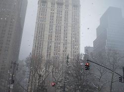 january 17 2026 new york new york usa pedestrians cross a street in manhattan s financial district in falling snow 1