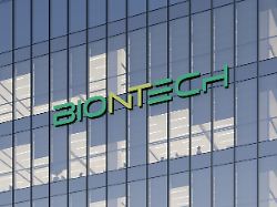 mainz germany october 31 2021 editorial use only 3d cgi biontech signage logo on top of glass building biotechnology company workplace in high rise office headquarters