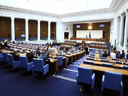 members of parliament watch live as bulgarian prime minister rosen zhelyazkov announces the resignation of his government in sofia bulgaria on december 11 2025