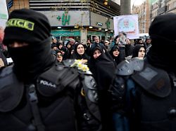 people attend the funeral of the security forces who were killed in the protests that erupted over the collapse of the currency s value in tehran iran january 14 2026