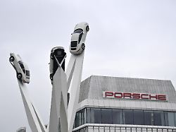 porsche zentrum zuffenhausen am porscheplatz porsche sportwagen haengen an stahltraegern und streben in die hoehe in stuttgart zuffenhausen werk konzernzentrale porsche schriftzug