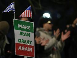 protesters hold up placards and flags as they demonstrate outside the iranian embassy in london monday jan 12 2026