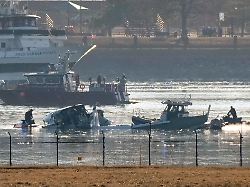 search and rescue efforts are seen around a wreckage site in the potomac river from ronald reagan washington national airport early thursday morning jan 30 2025 in arlington va