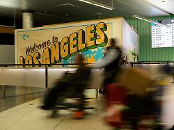 travelers push their luggage through the international arrivals area at the los angeles international airport in los angeles saturday june 8 2025