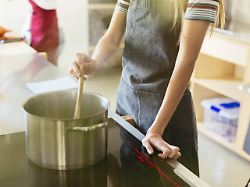 woman stirring in cooking pot in kitchen model released symbolfoto property released publicationxinxgerxsuixautxhunxonly ebsf02441