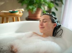 young woman relaxing in bubble bath at home spa young woman relaxing in bubble bath at home spa self care rituals