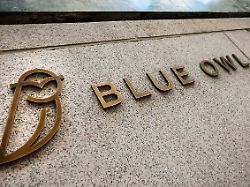 a logo for blue owl capital is displayed on a midtown manhattan office building in new york city u s february 24 2026