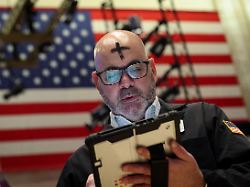 a trader with ash cross mark on his forehead for ash wednesday works on the floor at the new york stock exchange nyse in new york city u s february 18 2026