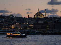 a vessel sails along the bosphorus strait as the ottoman al noor mosque appears in the background