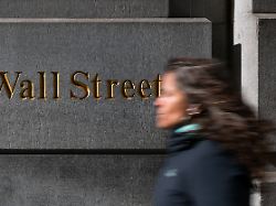 a woman walks down wall street in new york city u s april 8 2025