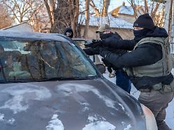 activists are approached by a federal agent brandishing a firearm for following agent vehicles on tuesday feb 3 2026 in minneapolis